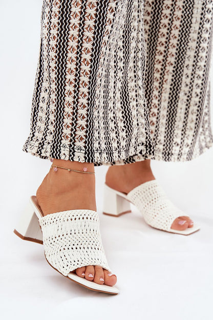 Chic women's braid design slippers by Step in Style, featuring a 6.5 cm heel. Perfectly styled for summer wear, these elegant sandals combine modern aesthetics with classic comfort, paired beautifully with a patterned maxi skirt.