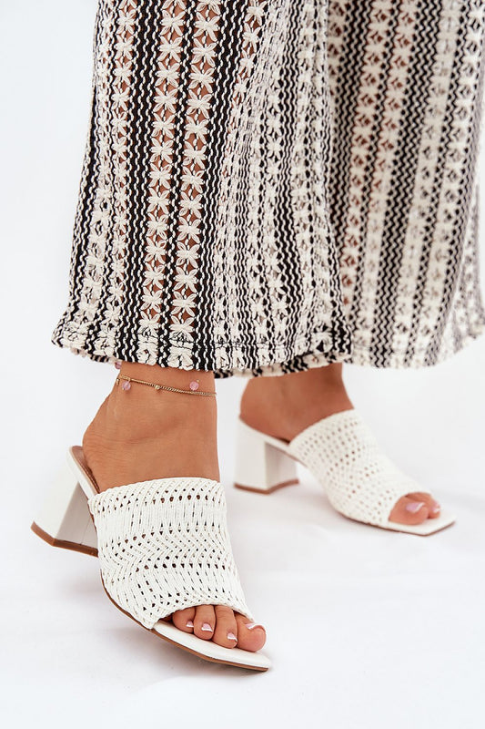 Chic women's braid design slippers by Step in Style, featuring a 6.5 cm heel. Perfectly styled for summer wear, these elegant sandals combine modern aesthetics with classic comfort, paired beautifully with a patterned maxi skirt.