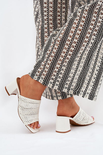 Stylish white women's slipper from Step in Style worn with flowing patterned trousers, showcasing a modern braid design and comfortable fit.