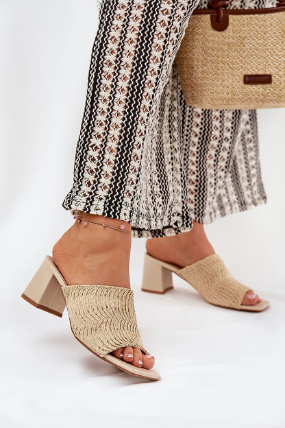 Sophisticated beige women's braid design slippers by Step in Style, paired with stylish patterned trousers, ideal for a summer outing.