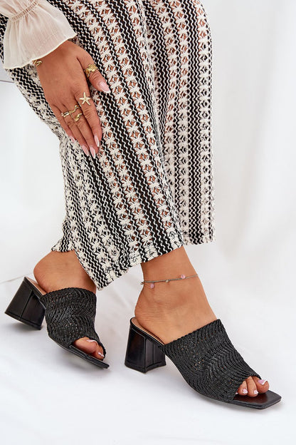 Refined black braid design slippers from Step in Style, elegantly displayed with a patterned skirt, designed for comfort and sophistication for the summer season.