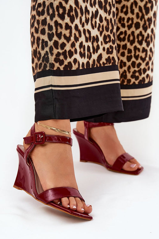 Elegant eco leather wedge sandals by Step in Style, showcased with a stylish ensemble featuring a leopard print pant. The adjustable buckle strap ensures a perfect fit, elevating your summer fashion.