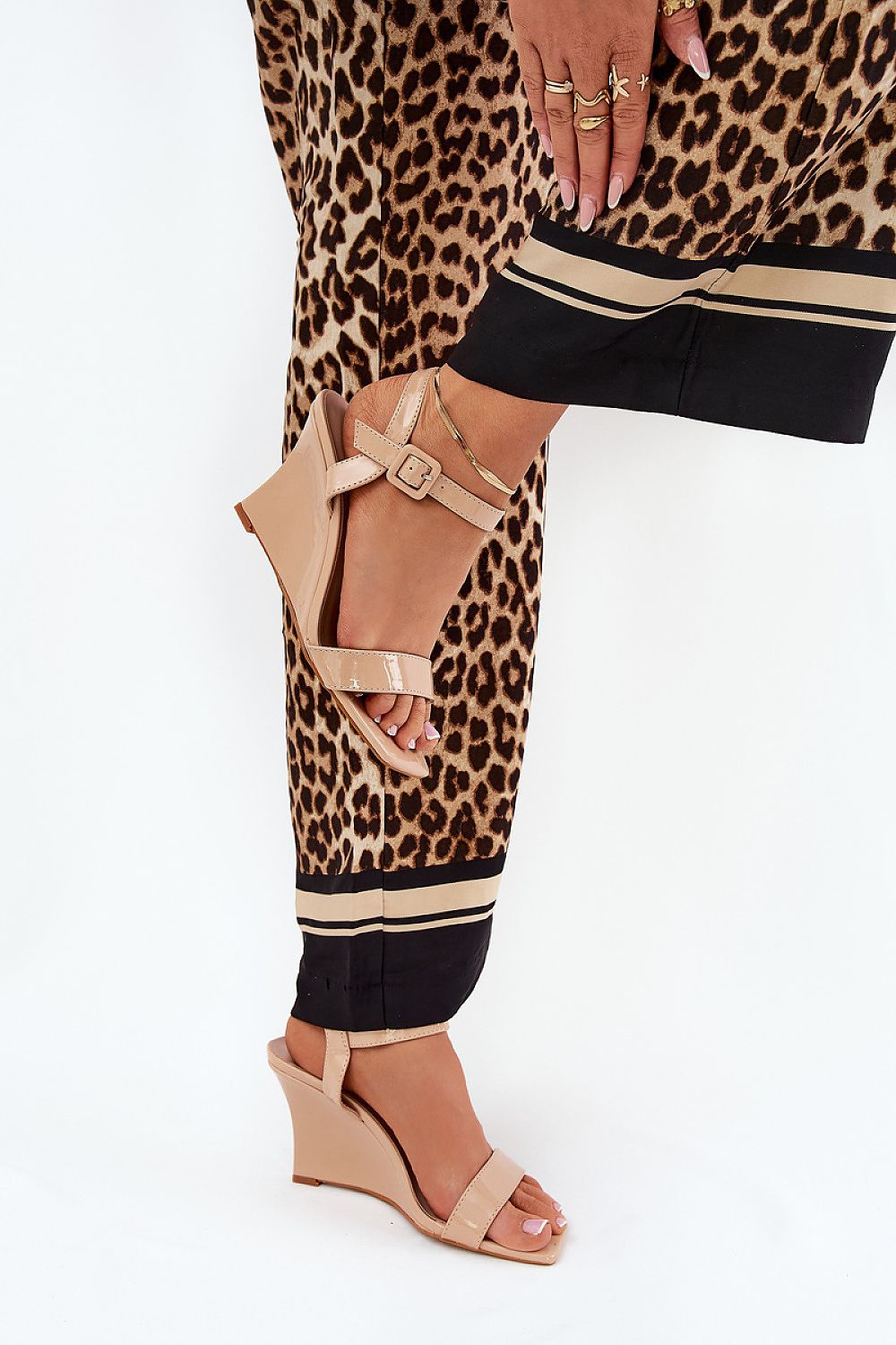 Stylish eco leather wedge sandals in nude, featuring an adjustable strap and elegant design, worn with trendy leopard print trousers, by Step in style.