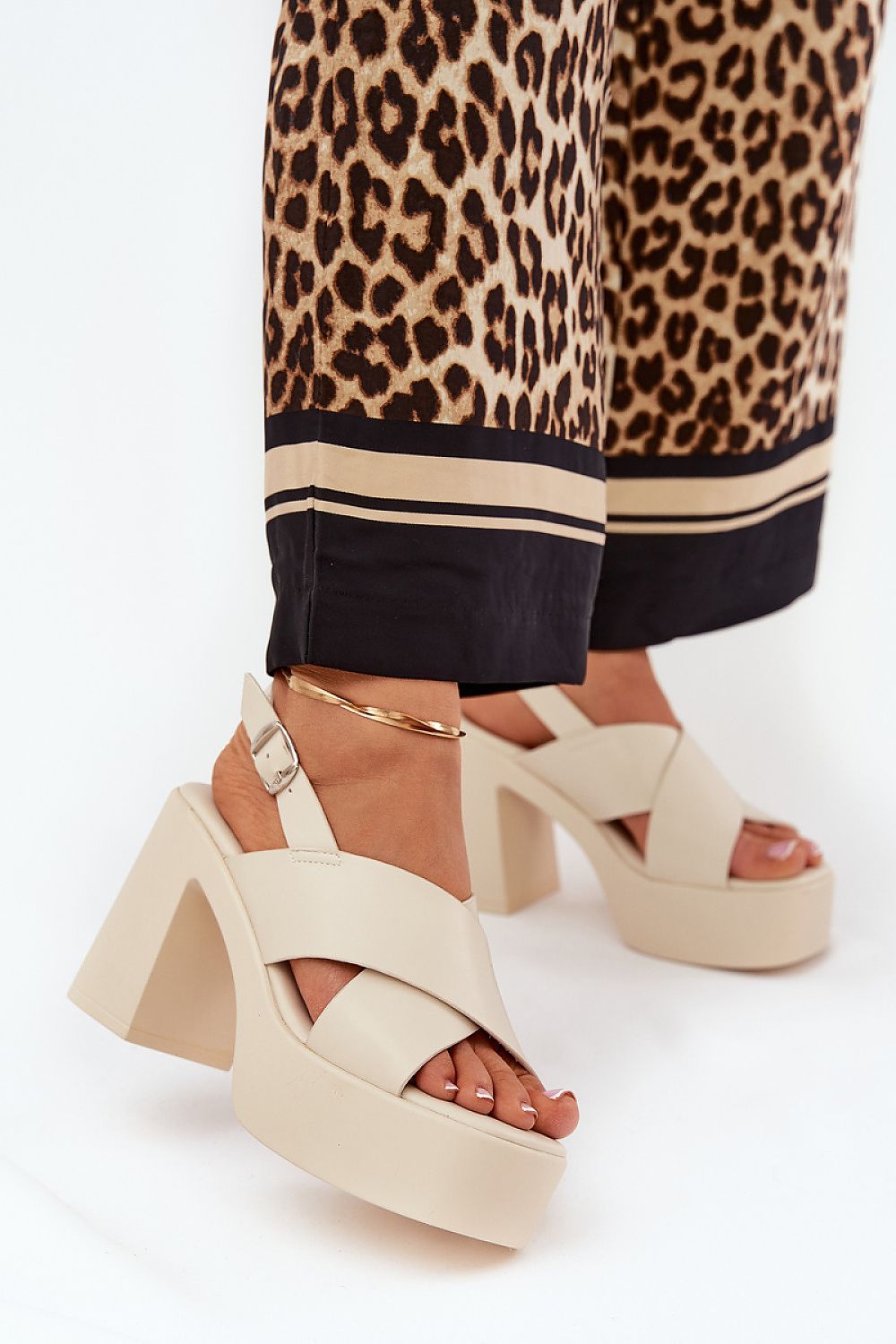 Elegant luxury eco leather heel sandals with intertwining straps, showcased against leopard print trousers, by Step in Style.