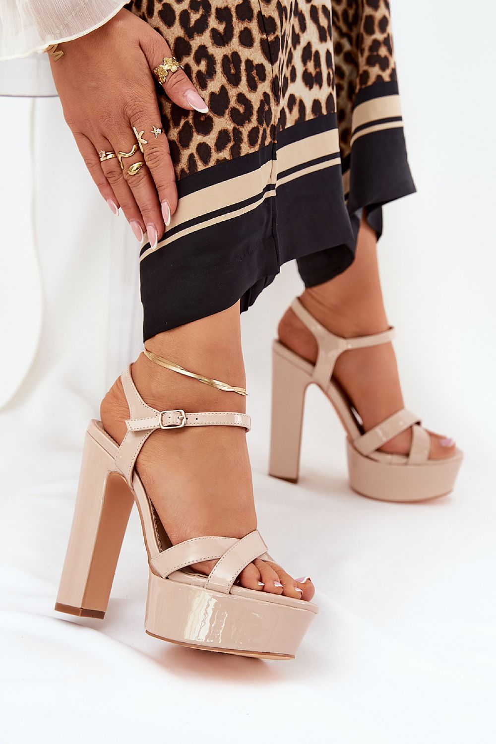 Luxury women's beige high block heel sandals from Step in Style, featuring adjustable ankle strap, elegant intertwining straps, and stylish platform heel.