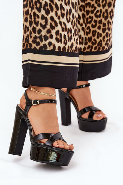 Chic black high block heel sandals from Step in Style, designed with adjustable ankle strap and stunning glossy finish for an elegant evening look.