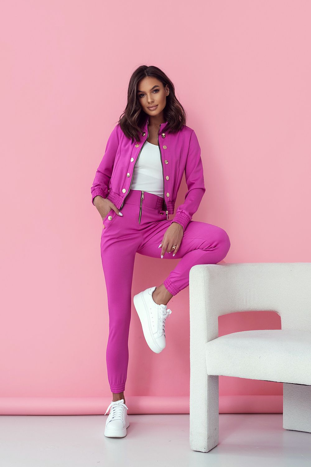 LaBalancia Women's Elegant Set in vibrant pink featuring a stylish long trouser and blouse combination. Model showcases the trendy outfit against a pink background, exuding comfort and luxury.