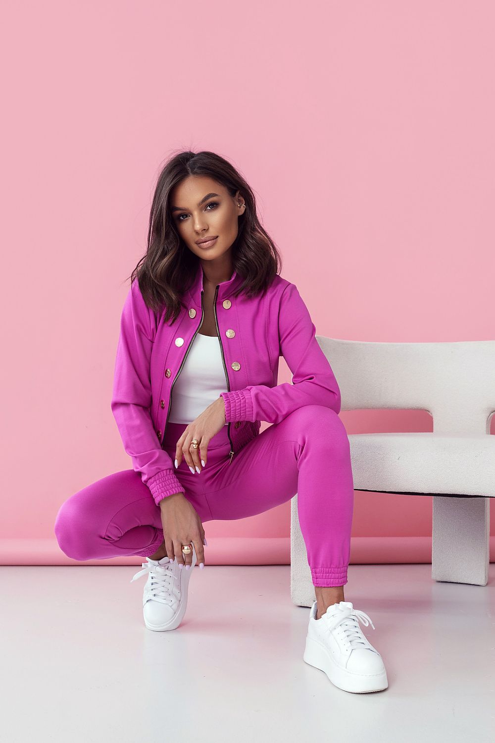 LaBalancia Women's Elegant Set in chic pink, model poses in a fashionable stance highlighting the sleek long trousers and elegant blouse. Captivating styling aimed at modern women who value sophistication and comfort.