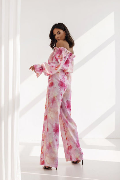 Stylish women's set from LaBalancia featuring an off-shoulder frilled blouse and high-waisted trousers in soft pastel pink hues, embodying grace and modern elegance.