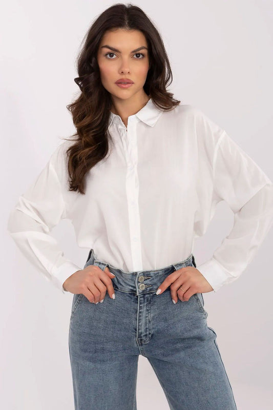 Elegant long sleeve women's white shirt by NM, featuring a fitted classic collar and a stylish silhouette, paired with high-waisted denim jeans in a timeless look.
