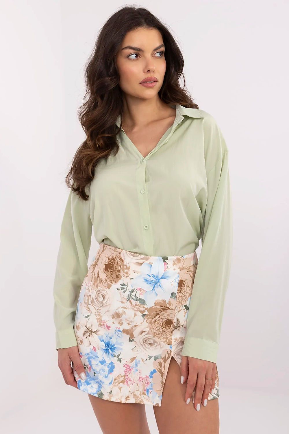 Sophisticated women's shirt by NM in soft green, featuring a fitted classic collar, paired with a floral mini skirt for a stylish ensemble.