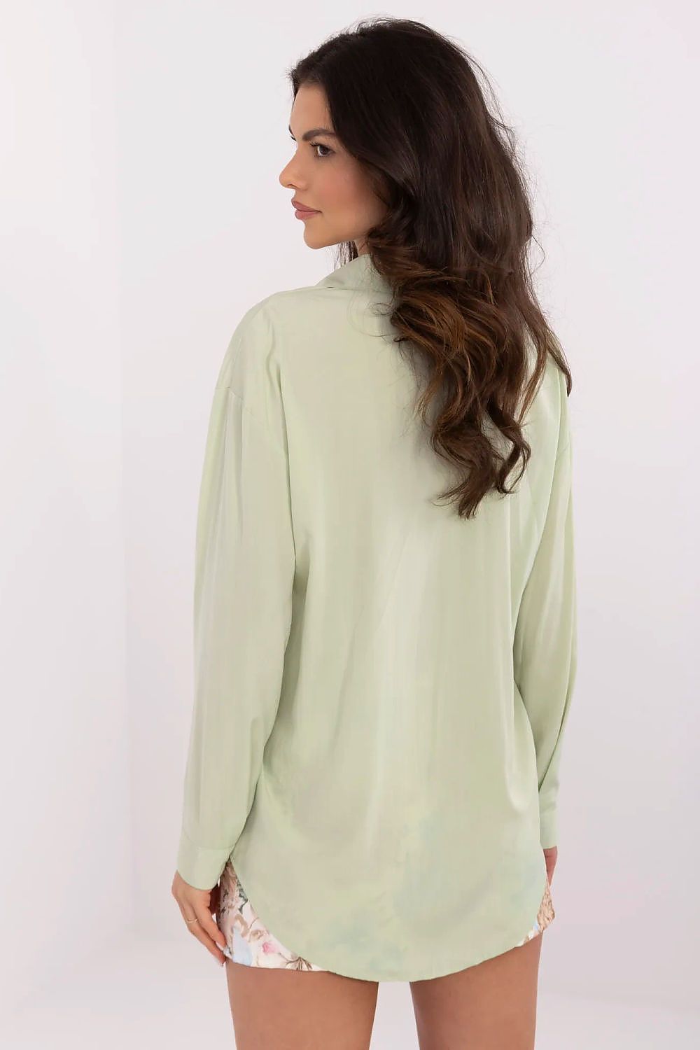 Back view of NM's luxurious long sleeve women's shirt in soft green, highlighting its classic collar and fitted design, perfect for versatile styling.