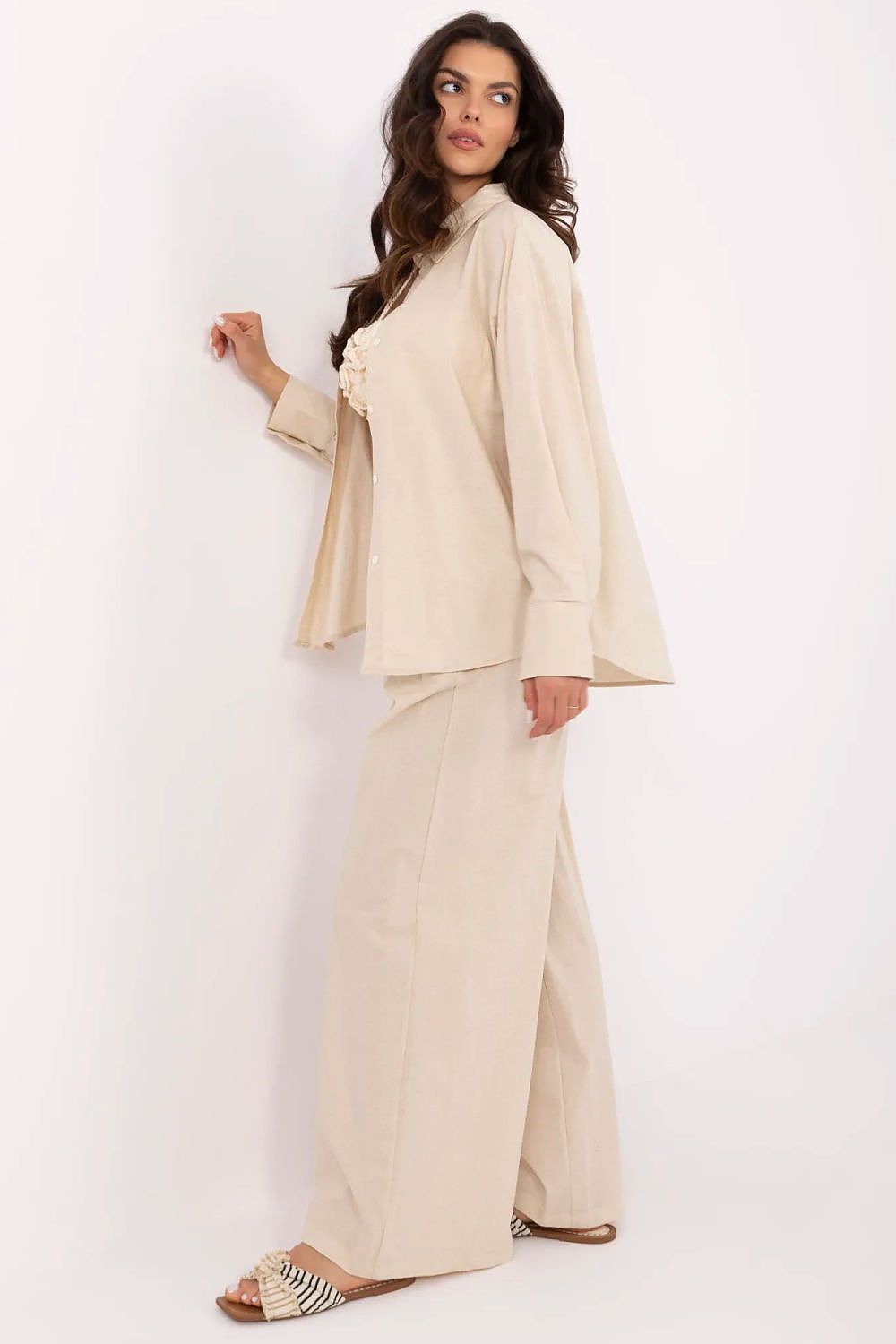 Side view of an elegant women's cotton-linen outfit showcasing long sleeves and wide-legged high-waisted trousers, crafted by NM.