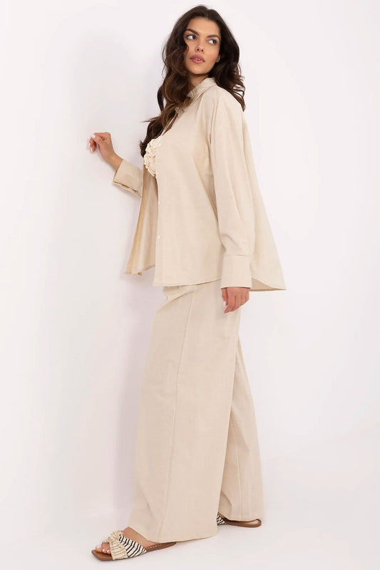 Side view of an elegant women's cotton-linen outfit showcasing long sleeves and wide-legged high-waisted trousers, crafted by NM.