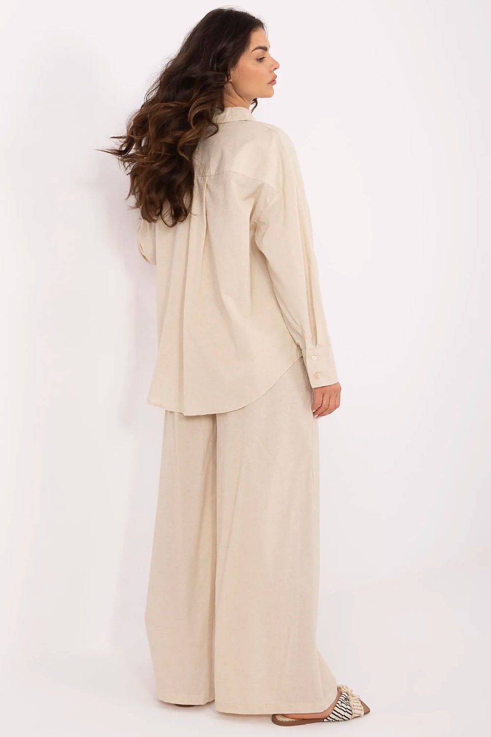 Back view of a sophisticated women's cotton-linen clothing set with a relaxed fit long sleeve shirt and flowing high-waisted pants, from NM.