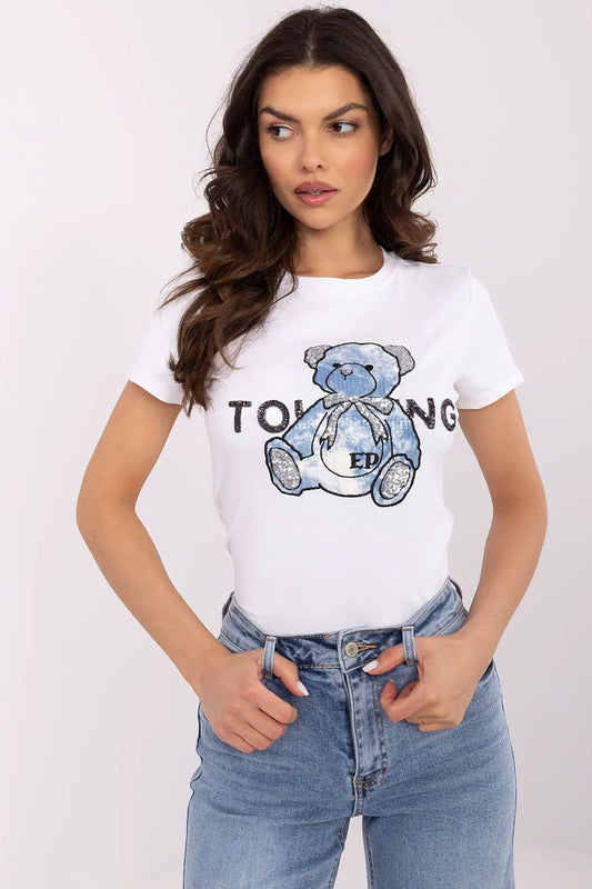Charming women's t-shirt by NM featuring teddy bear embroidery and sequins, model showcasing front view with stylish denim.