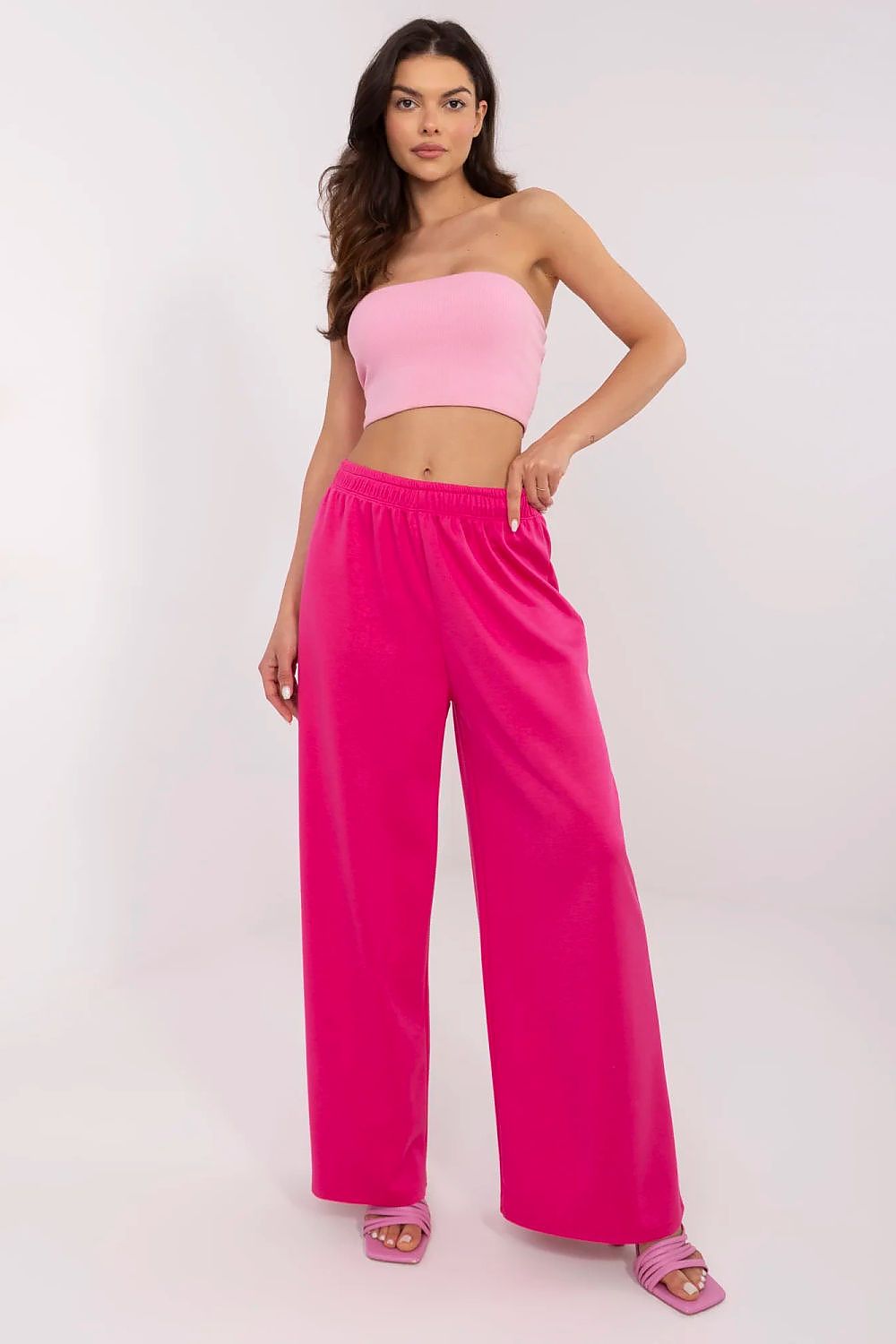 Chic front view of Italy Moda high waist wide leg tracksuit trousers in vibrant pink, paired with a matching crop top, perfect for stylish casual wear.