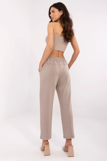 Rear view of high waist tracksuit trousers by Italy Moda in a creamy shade, highlighting the soft fabric and tailored fit that combines elegance and comfort effortlessly.