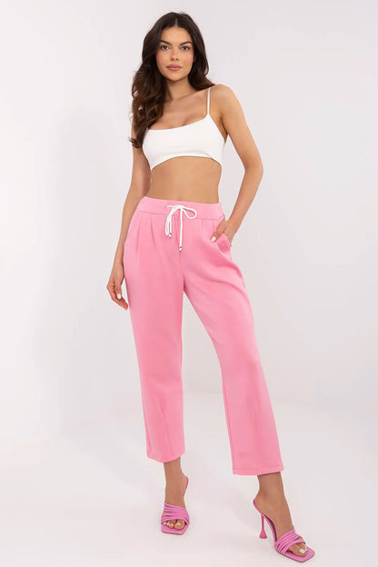 Italy Moda elegant high waist pink tracksuit trousers for women, featuring side pockets, styled with a white crop top and pink heels, perfect for casual or semi-formal occasions.