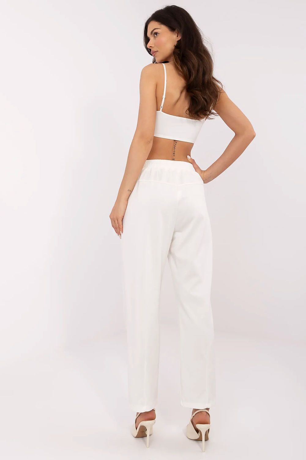 Sophisticated back view of women's white high waist tracksuit trousers from Italy Moda, emphasizing a fashionable silhouette with a tied waist for a perfect fit.