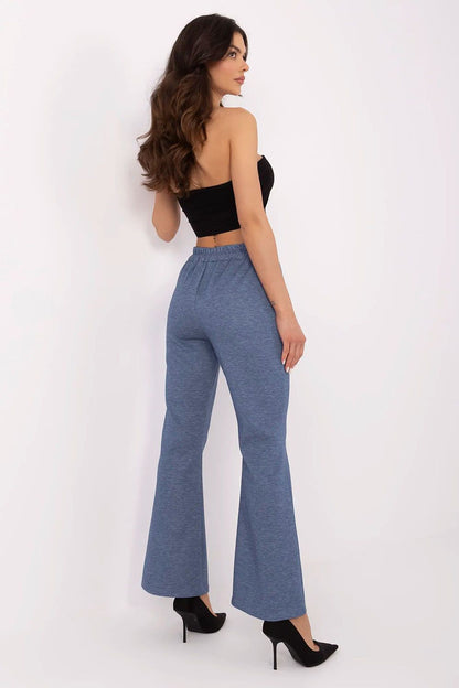 Back view of a fashionable woman wearing Italy Moda high waist bell-shaped sweatpants in blue, featuring an elastic waistband, demonstrating a comfortable and stylish casual look.