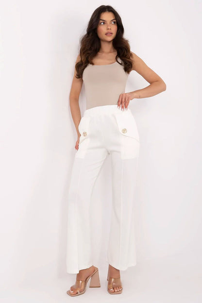 Chic white high waist bell-shaped sweatpants by Italy Moda, showcasing side pockets and decorative brooches, ideal for sophisticated casual styling.