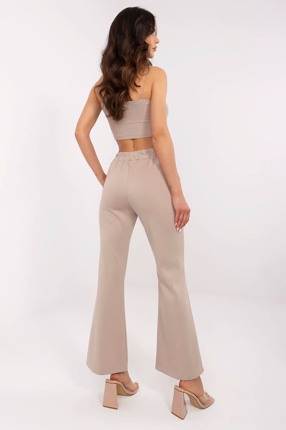 Chic back view of Italy Moda high waist bell-shaped sweatpants in beige, showcasing a comfortable elastic waistband and stylish silhouette, complemented by a trendy cropped top.