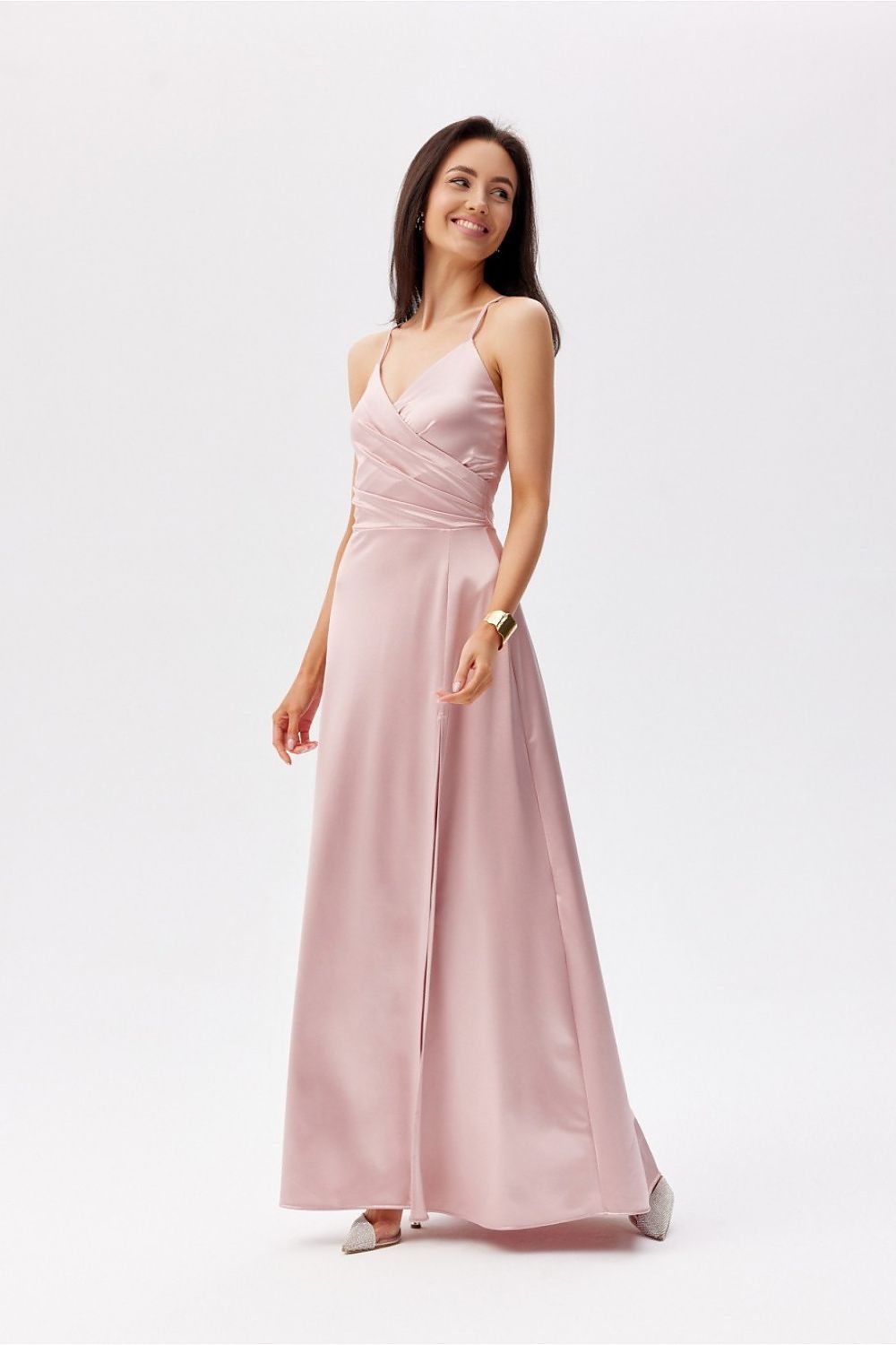 Elegant Roco Fashion maxi dress with thin straps, featuring a wrap-around top and a leg slit, showcased in a soft pink hue.