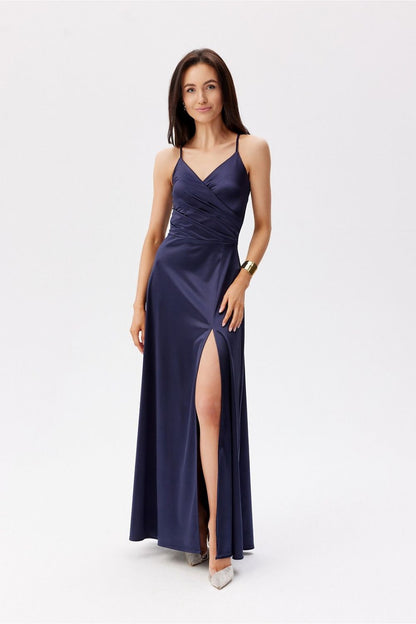 Sophisticated navy blue Roco Fashion maxi dress featuring thin straps and a seductive leg slit, perfect for a glamorous evening.