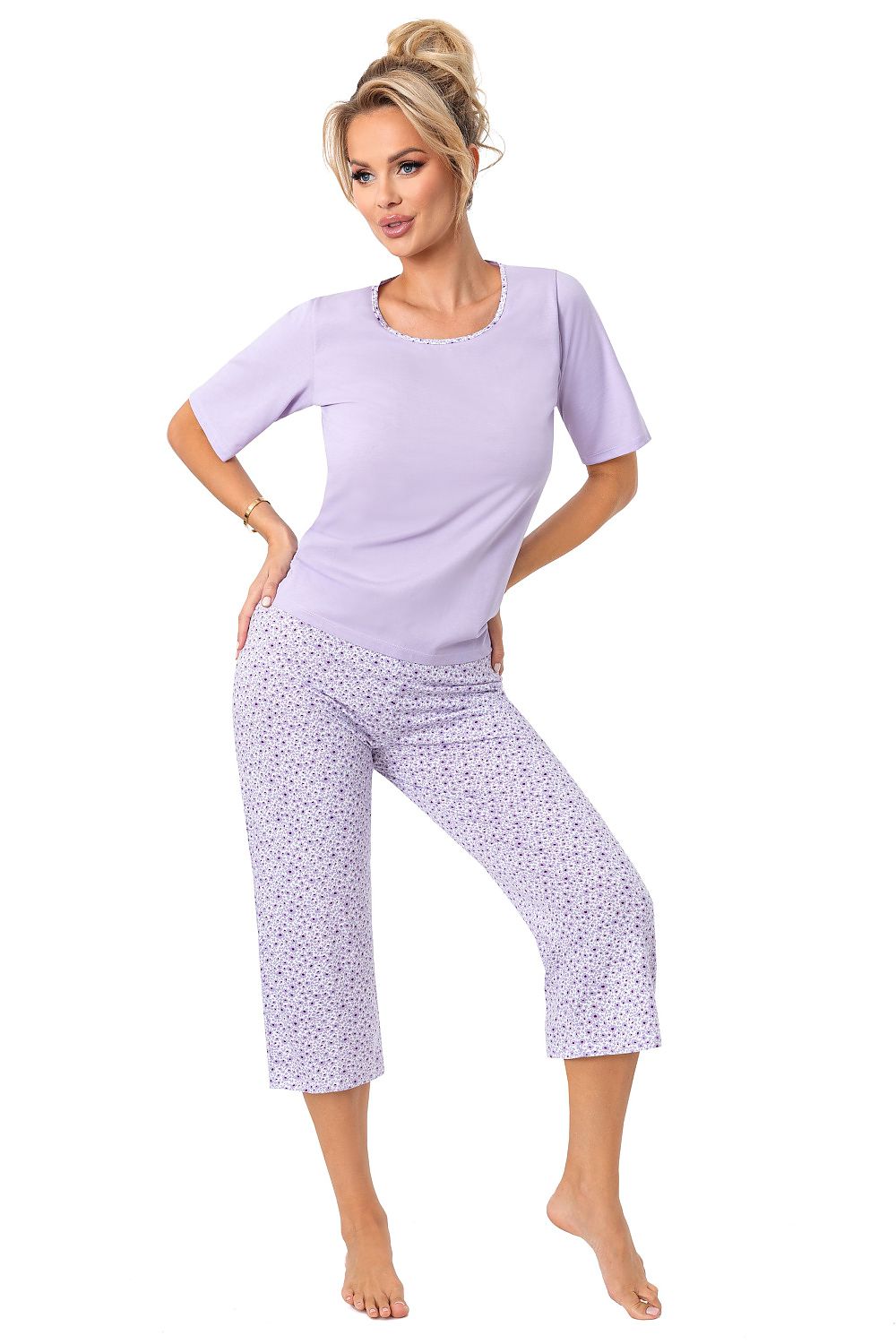 Luxurious women's cotton pyjama set by Donna, featuring a stylish short sleeve top and trendy 3/4 shorts in a delicate lilac print, perfect for elegant lounging and relaxation.