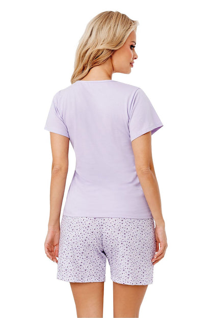 Elegant back view of a woman wearing a luxury cotton pyjama set by Donna, featuring a short sleeve lilac blouse and trendy printed shorts, showcasing comfort and style.