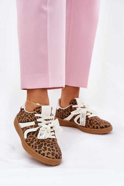 Stylish women's eco leather sneakers in leopard print detail, showcasing lace decoration, paired with chic pink trousers by Step in Style.