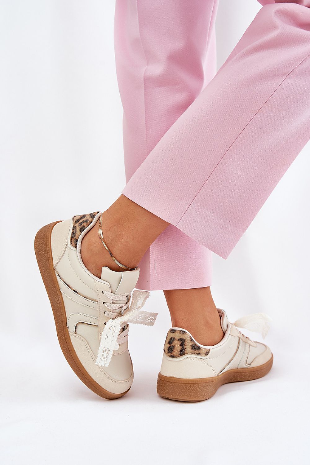 Stylish rear view of a woman wearing beige eco leather sneakers with leopard print by Step in Style, complemented by pink trousers for a refined everyday look.
