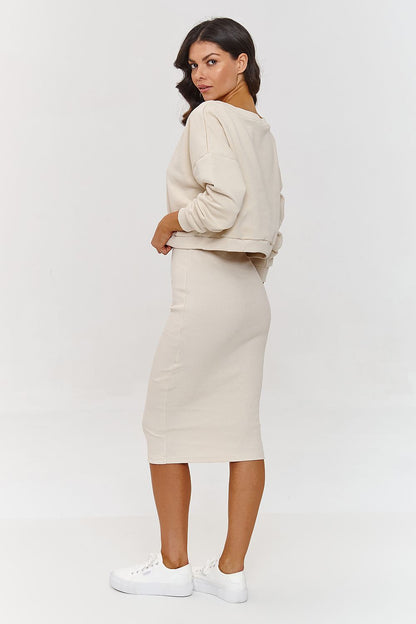 Stylish model wearing Makadamia's Women's Midi Tracksuit Set, highlighted by a V-neckline and versatile casual elegance.