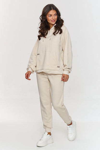 Stylish model wearing the Makadamia hoodie and pants set, exemplifying effortless elegance and comfort.