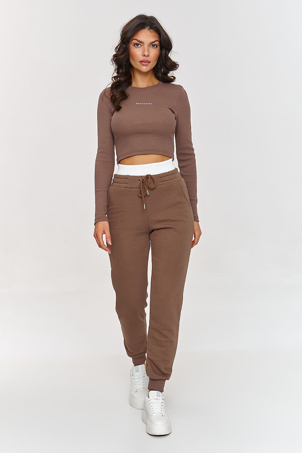 Makadamia's cotton set ensemble, including a fitted long sleeve shirt and loose sweatpants, epitomising sporty elegance for sizes 36-38.