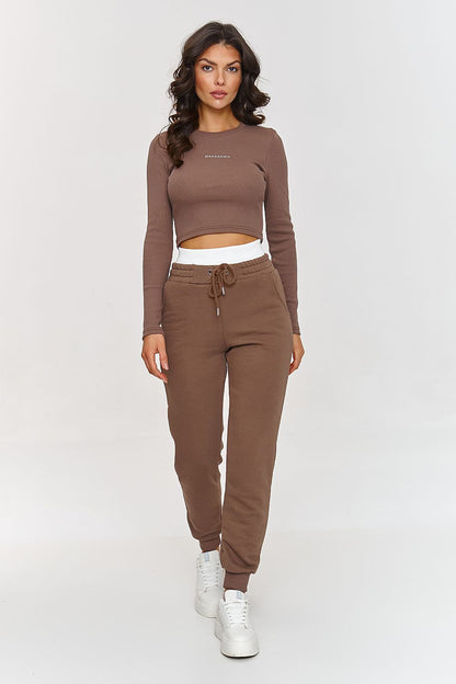 Makadamia's cotton set ensemble, including a fitted long sleeve shirt and loose sweatpants, epitomising sporty elegance for sizes 36-38.