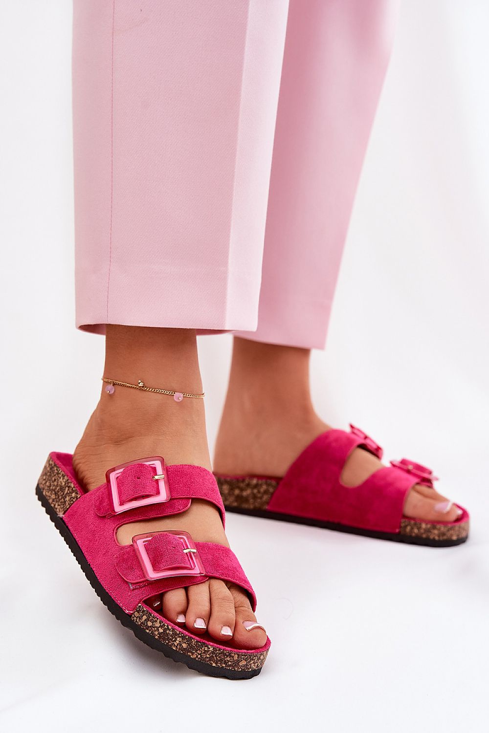Elegant pink eco suede sandals showcasing stylish buckle accents, worn casually with tailored pants, designed for comfort by Step in Style.