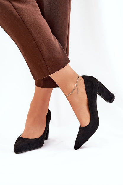 Elegant black eco suede block heel pumps by Step in Style, showcased on a model's foot with stylish brown trousers, presenting a sophisticated and luxurious look.