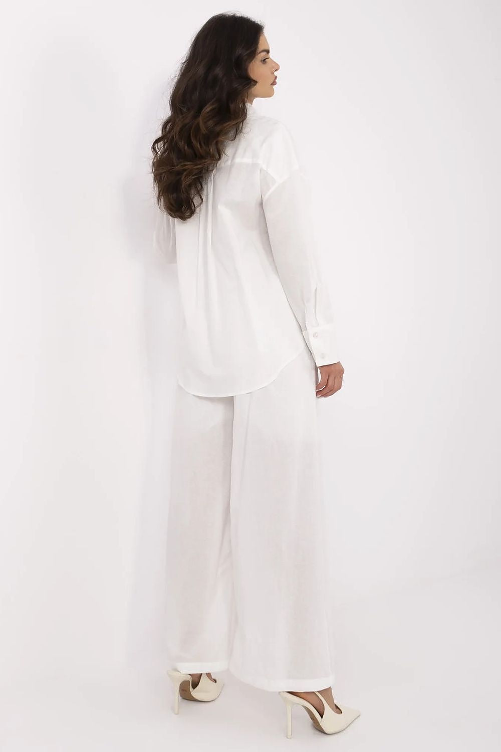 Back view of a luxurious women's cotton-linen outfit in white, showcasing a long sleeve top paired with high-waisted trousers, designed by NM.