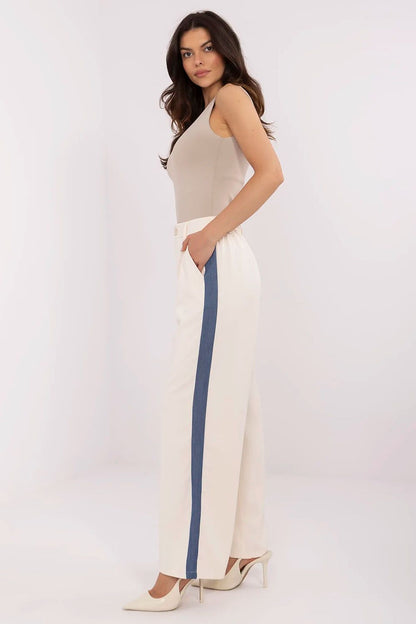 Close-up of the NM luxury trousers highlighting the sophisticated side pockets and modern contrasting stripes, ideal for effortless style.