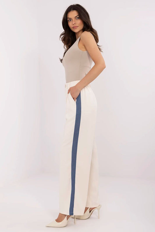 Close-up of the NM luxury trousers highlighting the sophisticated side pockets and modern contrasting stripes, ideal for effortless style.