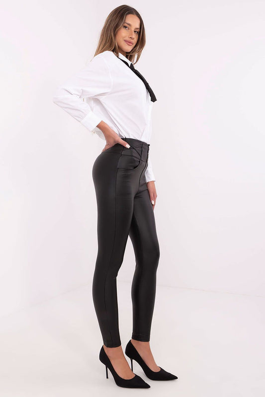 Stylish high waist skinny leatherette trousers for women from NM, featuring tapered legs and decorative buttons, ideal for a sophisticated look on cooler days.