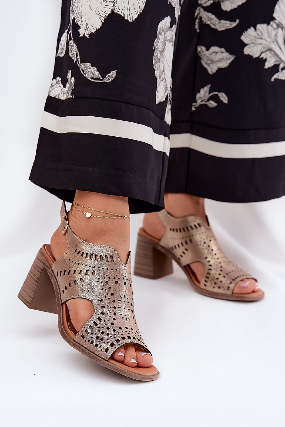 Model wearing Jezzi Women's Eco Leather Heel Sandals, elegantly styled for summer fashion, emphasizing the comfort and adjustable features by Step in Style.