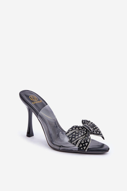 Close-up of Step in Style's stunning transparent high-heeled sandals with a glamorous bow, highlighting the chic and fashionable elements ideal for elegant outfits.