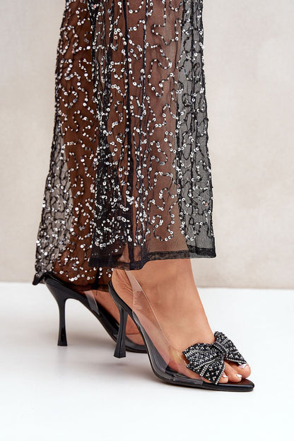 Stylish display of Step in Style's high-heeled sandals with a shiny bow, tailored for sophisticated events and ideal for pairing with cocktail dresses, available in various sizes.