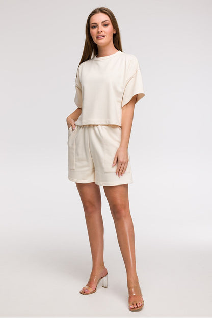 Chic BeWear women's boxy fit cropped blouse displayed on a model, highlighting its comfortable fit and breathable fabric, ideal for holiday and city wear.