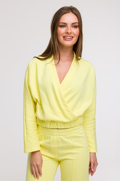 Stylised shot of BeWear's Women's V-Wrap Blouse showcasing the loose fit and elastic waistband, accentuating feminine shapes beautifully.