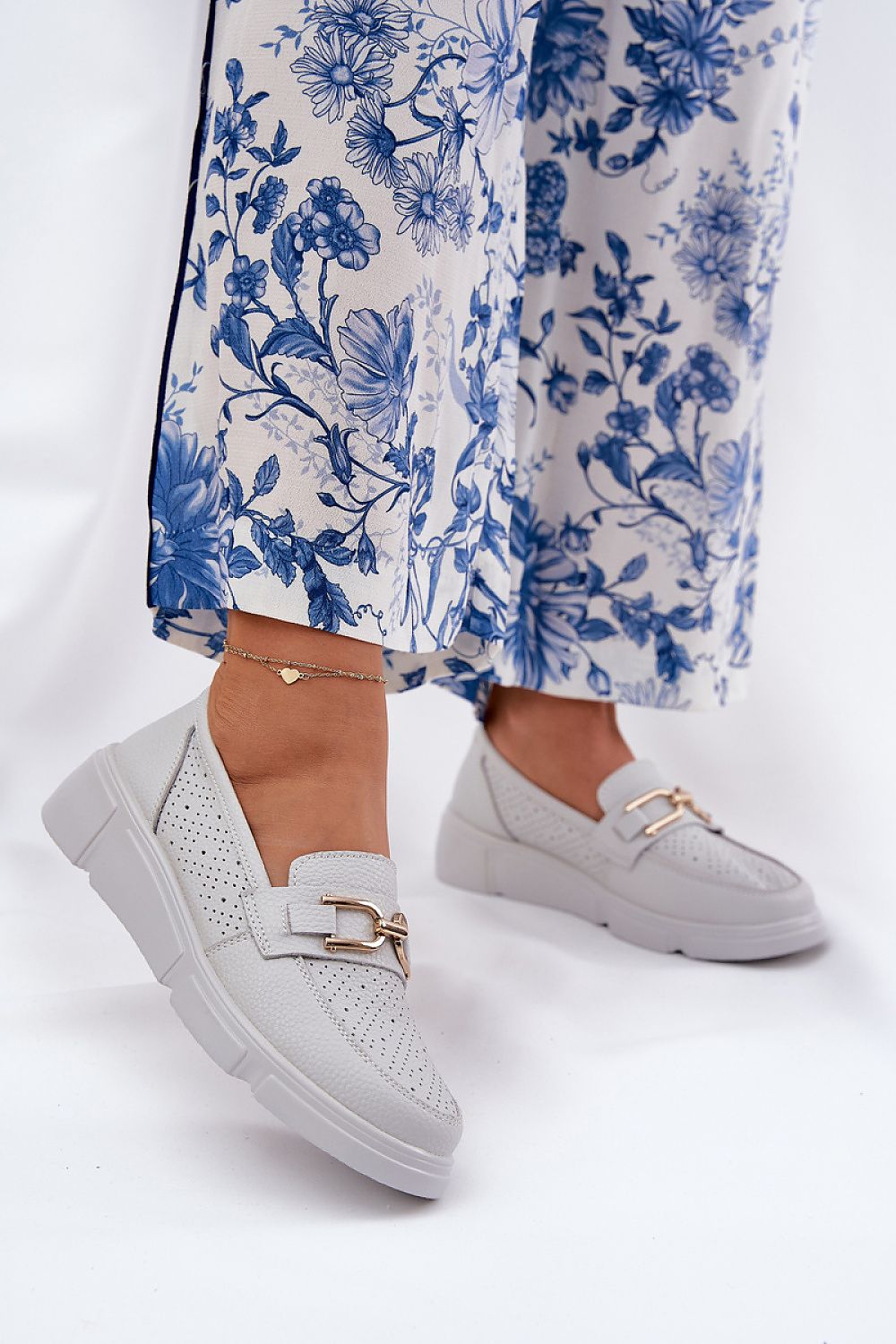 Elegant women's leather moccasins with a wedge heel by Step in style, featuring a comfort fit design, rounded toes, and a subtle gold ornament, ideal for both casual and sophisticated looks in sizes EU 36-40.