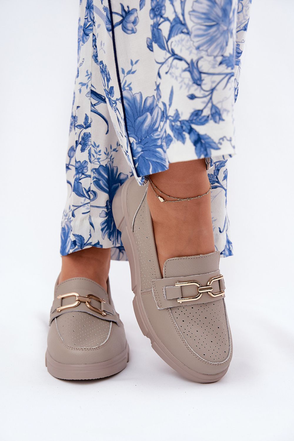 A pair of Step in Style women's leather moccasins on a stylish background, highlighting the delicate wedge heel and versatility for casual and elegant outfits.